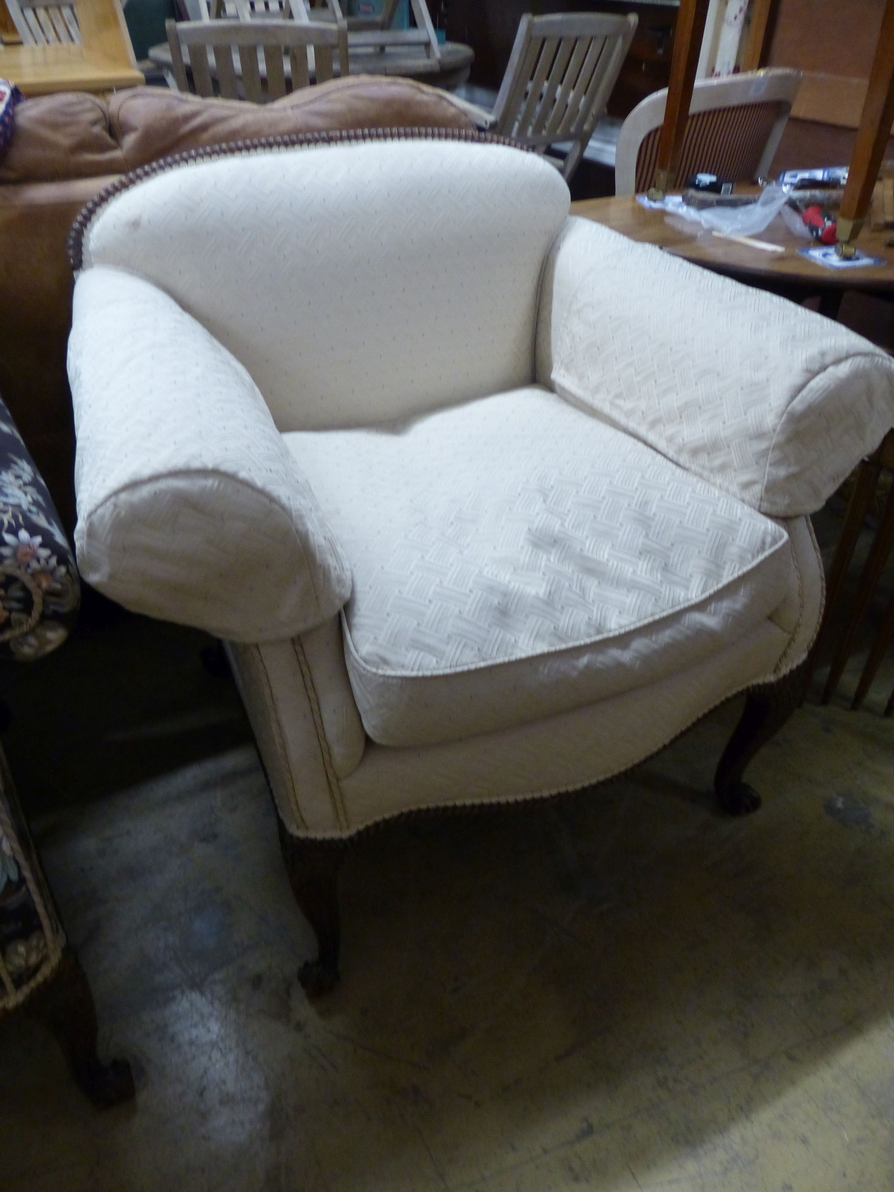 A late 19th century Continental mahogany scroll arm sofa and armchair, sofa upholstered in a floral fabric, on carved cabriole legs W 200 D 86 H 81 cms